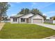 Charming single-story home featuring a two-car garage, well-manicured lawn, and neutral-toned exterior at 508 Churchill Pl, Poinciana, FL 34759