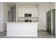 Open kitchen featuring white cabinets, granite countertops, stainless appliances, and gray wood floors at 508 Churchill Pl, Poinciana, FL 34759