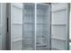 Interior view of a new, clean stainless steel refrigerator with adjustable shelves at 508 Churchill Pl, Poinciana, FL 34759
