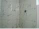 Shower with marble tile surround and modern chrome shower head at 508 Churchill Pl, Poinciana, FL 34759