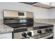 Modern stainless steel stove with black cooktop and granite countertops at 508 Churchill Pl, Poinciana, FL 34759