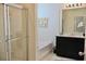 Bright bathroom featuring a glass enclosed shower, granite countertops and dark cabinets at 5273 Oakbourne Ave, Davenport, FL 33837