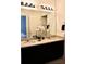 Elegant bathroom featuring a double sink vanity, granite countertops and a large mirror at 5273 Oakbourne Ave, Davenport, FL 33837