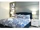 This bedroom features a queen-size bed, hardwood floors, and bedside tables at 5273 Oakbourne Ave, Davenport, FL 33837