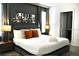 Modern bedroom with sleek gray walls, and a luxurious bed with stylish decor at 5273 Oakbourne Ave, Davenport, FL 33837