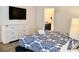 Comfortable bedroom featuring a TV, dresser and blue comforter set at 5273 Oakbourne Ave, Davenport, FL 33837