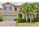 Charming two-story home featuring a well-manicured lawn and beautiful landscaping, offering great curb appeal at 5273 Oakbourne Ave, Davenport, FL 33837