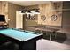 Spacious game room featuring a pool table, ping pong table and industrial decor at 5273 Oakbourne Ave, Davenport, FL 33837