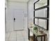Bright, tiled entryway adorned with decorative mirrors and a console table, creating a welcoming ambiance at 5273 Oakbourne Ave, Davenport, FL 33837