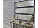 Inviting tiled entryway enhanced by decorative mirrors and a stylish console table with accent pieces at 5273 Oakbourne Ave, Davenport, FL 33837