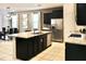 Modern kitchen with dark cabinetry, stainless steel appliances, and a granite island, perfect for cooking at 5273 Oakbourne Ave, Davenport, FL 33837