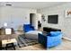 Inviting living room with modern decor, brick accent wall, and comfortable seating arrangement at 5273 Oakbourne Ave, Davenport, FL 33837