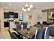 Open-concept living space featuring modern decor connecting the kitchen, dining and living areas at 5273 Oakbourne Ave, Davenport, FL 33837