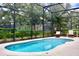 Relaxing private pool with screened enclosure and lounge chairs surrounded by lush landscaping at 5273 Oakbourne Ave, Davenport, FL 33837