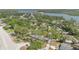 Serene aerial perspective of the home, boasting mature trees and proximity to the waterfront at 5505 W Magnolia Ave, Port Orange, FL 32127