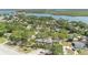 Breathtaking aerial view of the property near the water, enveloped by lush greenery and mature trees at 5505 W Magnolia Ave, Port Orange, FL 32127