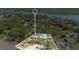 Expansive aerial view highlighting the property's location, surrounded by mature trees and near the waterfront at 5505 W Magnolia Ave, Port Orange, FL 32127
