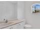 Bright bathroom with a large mirror, neutral-toned vanity, and a window providing natural light at 5505 W Magnolia Ave, Port Orange, FL 32127