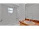 Bathroom featuring white tiled walls, a tub, toilet, vanity and mirror at 5505 W Magnolia Ave, Port Orange, FL 32127