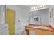 Bathroom featuring a shower, toilet, sink and bright yellow door at 5505 W Magnolia Ave, Port Orange, FL 32127