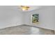 An empty bedroom with white walls, tile floor, and a ceiling fan at 5505 W Magnolia Ave, Port Orange, FL 32127