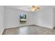 An empty bedroom with white walls and a window with a view at 5505 W Magnolia Ave, Port Orange, FL 32127