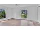 Bedroom featuring white walls, tiled floors, and windows with outdoor view at 5505 W Magnolia Ave, Port Orange, FL 32127