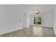Bright dining room featuring tile flooring, archway, and a large window with a pleasant view, ideal for Gathering meals at 5505 W Magnolia Ave, Port Orange, FL 32127