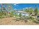 A cozy single-story home surrounded by lush landscaping and mature trees, offering privacy and serenity at 5505 W Magnolia Ave, Port Orange, FL 32127