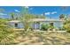 Charming single-story home boasts a well-manicured lawn and attractive landscaping at 5505 W Magnolia Ave, Port Orange, FL 32127