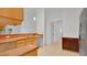 Kitchen with wood cabinets, stainless steel refrigerator, and tile floors at 5505 W Magnolia Ave, Port Orange, FL 32127