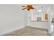 Open-concept living area with tile flooring, ceiling fan, and adjacent kitchen area, perfect for entertaining at 5505 W Magnolia Ave, Port Orange, FL 32127