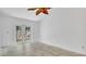 Bright living room with tile flooring and glass doors that lead to the backyard, flooding the space with natural light at 5505 W Magnolia Ave, Port Orange, FL 32127