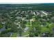 Expansive aerial view shows homes nestled among lush trees in a quiet community with easy access to a nearby lake at 656 Lake Charm Dr, Oviedo, FL 32765