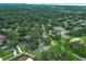 An aerial view of a lovely neighborhood showcasing homes nestled among lush trees and a serene pond at 656 Lake Charm Dr, Oviedo, FL 32765