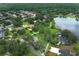 Great view of home near lake, surrounded by lush trees and greenery, showing its prime location within a community at 656 Lake Charm Dr, Oviedo, FL 32765