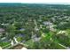 An aerial view of a lovely neighborhood showcasing homes nestled among lush trees and a serene pond at 656 Lake Charm Dr, Oviedo, FL 32765