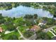 Beautiful aerial view of a well-maintained home site with mature trees and proximity to a serene lake at 656 Lake Charm Dr, Oviedo, FL 32765