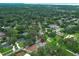 Expansive aerial view of a home nestled within a lush, green landscape with mature trees and nearby waterway at 656 Lake Charm Dr, Oviedo, FL 32765