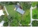 An aerial view shows a well-maintained home with a spacious yard, and ample surrounding greenery at 656 Lake Charm Dr, Oviedo, FL 32765