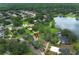 Scenic aerial view of a well-maintained home site surrounded by mature trees in a lakeside community at 656 Lake Charm Dr, Oviedo, FL 32765