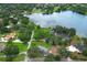 Stunning aerial view of a lakeside property showcasing lush landscaping and tranquil waterfront living at 656 Lake Charm Dr, Oviedo, FL 32765