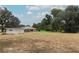 Expansive backyard with lush greenery, mature trees and a charming outbuilding and shed at 656 Lake Charm Dr, Oviedo, FL 32765