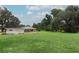 Expansive backyard features lush green grass and mature trees at 656 Lake Charm Dr, Oviedo, FL 32765