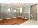 Basement with nautical wallpaper, faux wood panelling, and adjacent bathroom with tile at 656 Lake Charm Dr, Oviedo, FL 32765