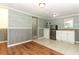Basement with nautical wallpaper, stainless fridge and white cabinets with sink at 656 Lake Charm Dr, Oviedo, FL 32765