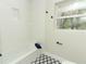 Updated bathroom features shower and tub, classic tile flooring, and stylish black hardware at 656 Lake Charm Dr, Oviedo, FL 32765