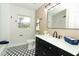 Updated bathroom with black vanity, white countertop, black fixtures, and decorative patterned tile floor at 656 Lake Charm Dr, Oviedo, FL 32765