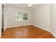 Bedroom with hardwood floors, neutral walls, ceiling fan, and a window providing natural light at 656 Lake Charm Dr, Oviedo, FL 32765