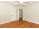Bedroom featuring hardwood floors, a ceiling fan, and a door leading to other rooms at 656 Lake Charm Dr, Oviedo, FL 32765
